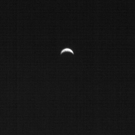 A crescent image of Earth in black and white