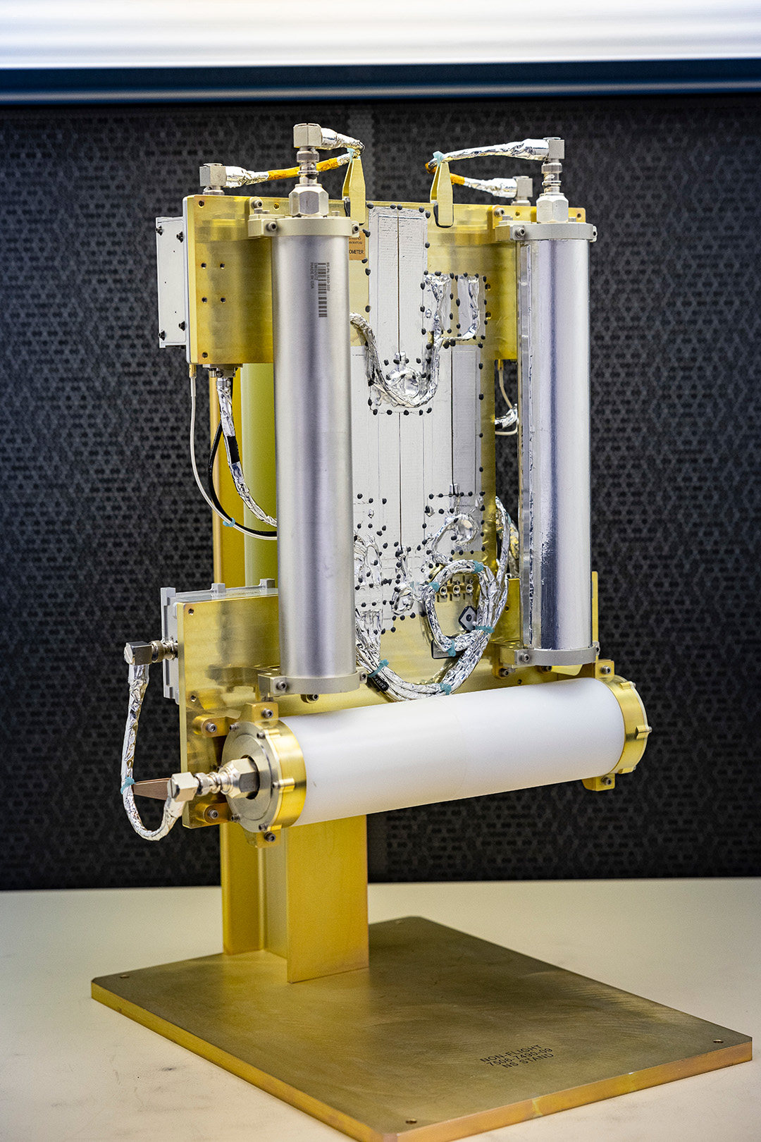 An image of three tubes mounted on a gold platform, the neutron spectrometer