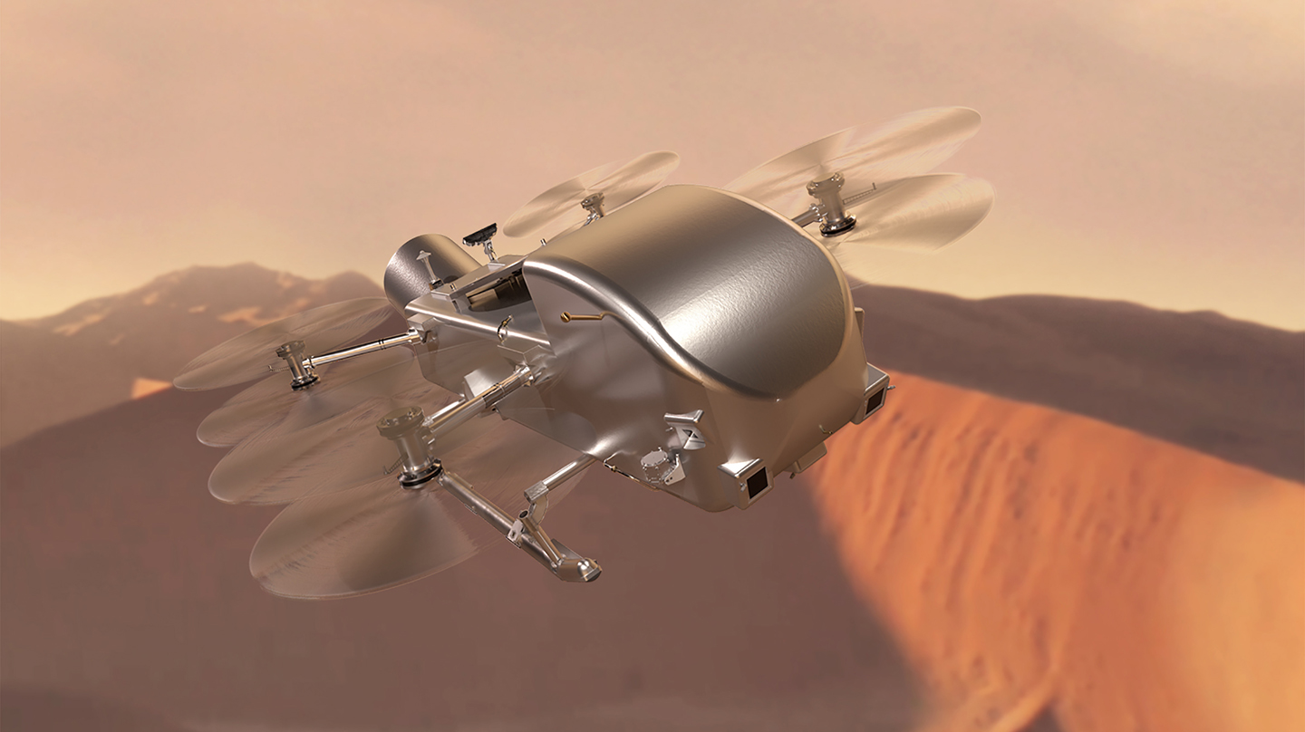 An artist's depiction of the silver-colored Dragonfly spacecraft flying over rust-colored dunes and against a hazy, orange sky