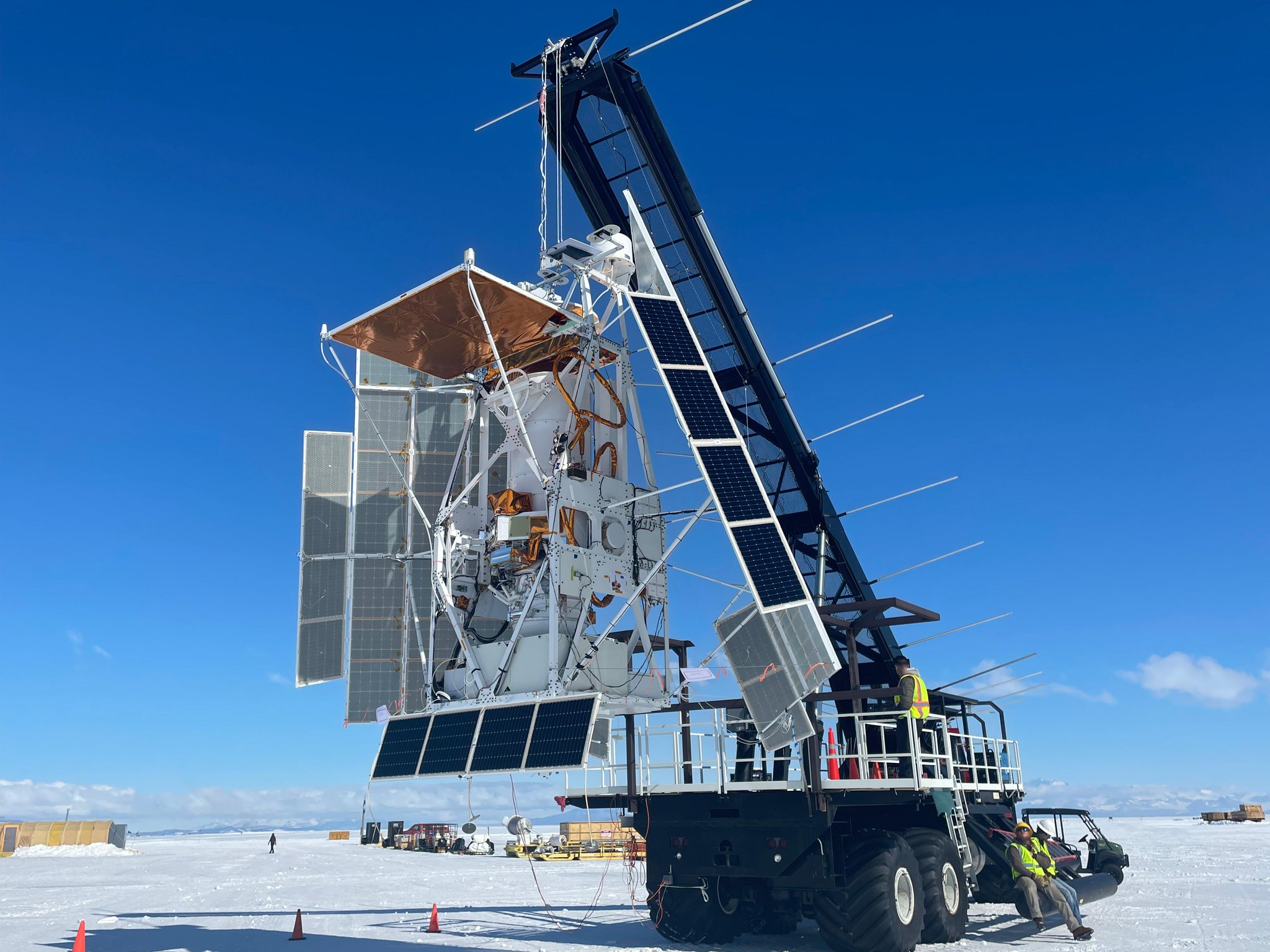A crane holding the GUSTO gondola and telescope sits out on the ice of Antarctica