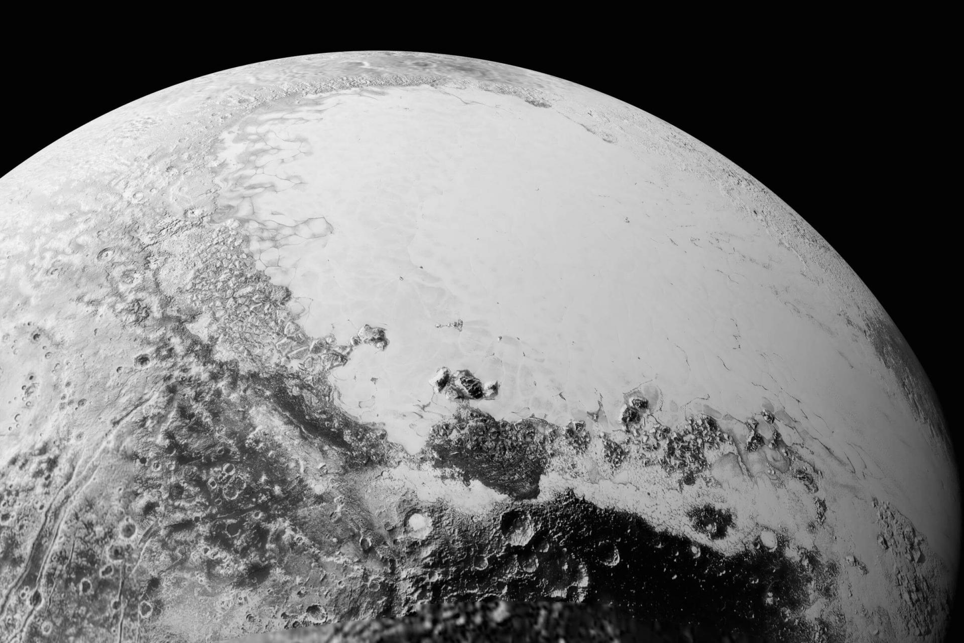 Close up view of Pluto's large heart-shaped glacier and mountains of ice.