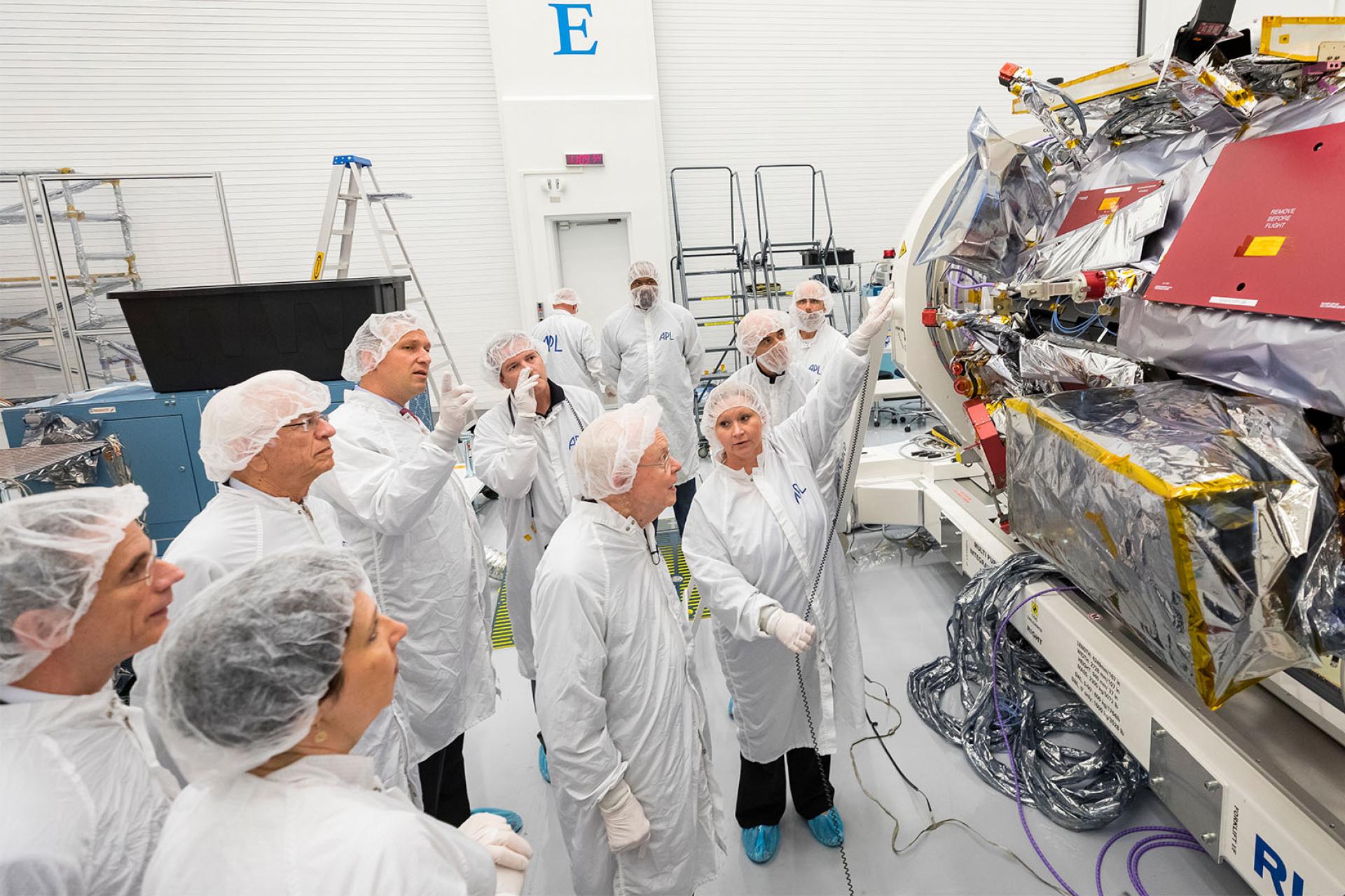 Eugene Parker, professor emeritus at the University of Chicago, visits the spacecraft that bears his name, in October 2017. Engineers in the clean room at APL, which built and now operates Parker Solar Probe, point out the instruments that are now collecting data from inside the Sun’s atmosphere.
