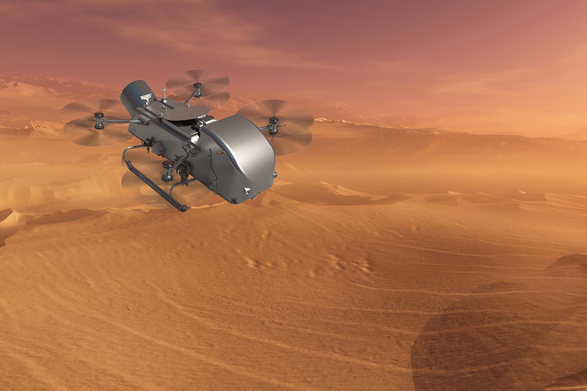 A silver drone-like rotocraft flies over a desert of tan-colored dunes and a hazy, orange sky