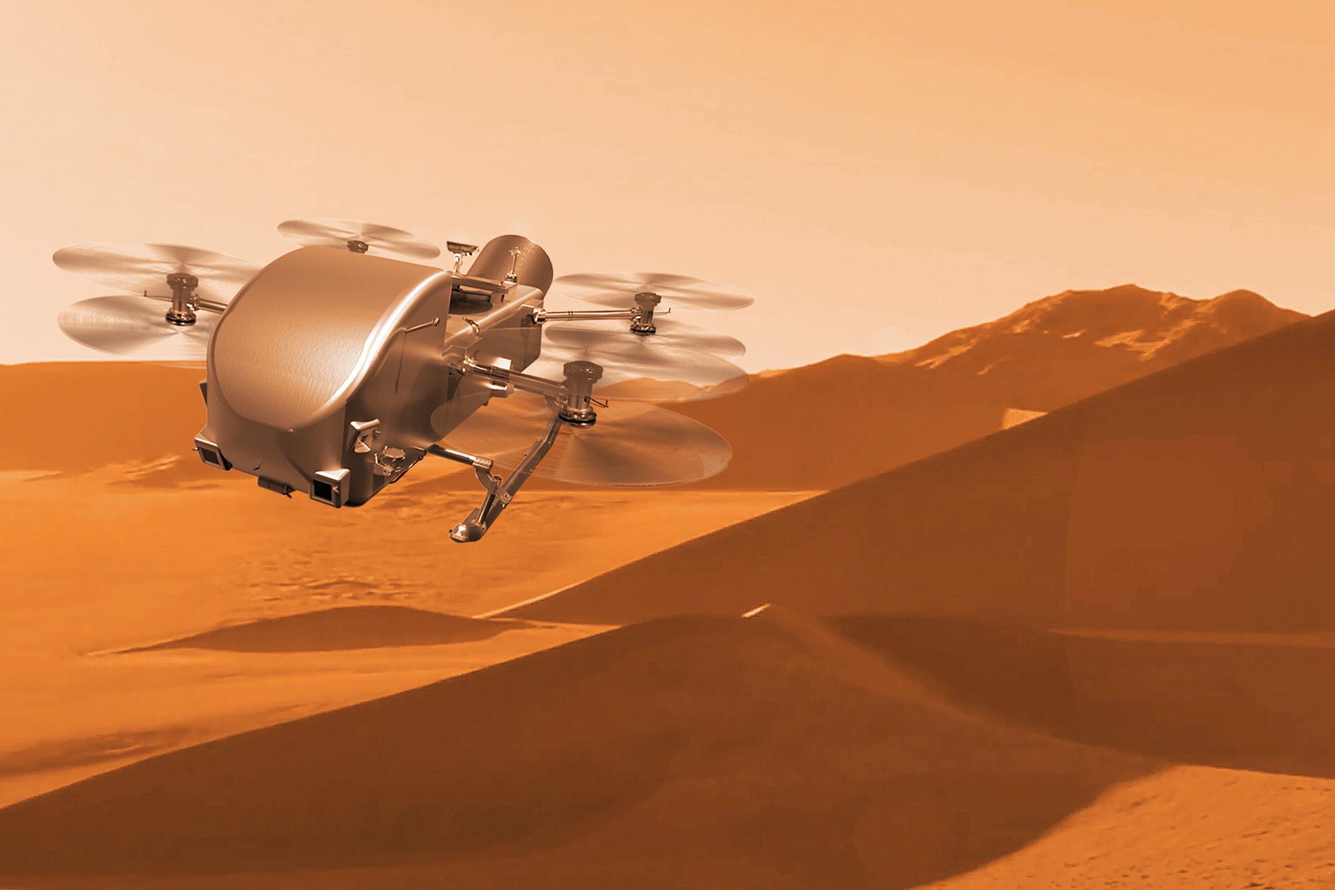 A silver drone-like rotocraft flies over a desert of tan-colored dunes and a hazy, orange sky