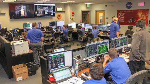 APL staff working in APL's mission control room