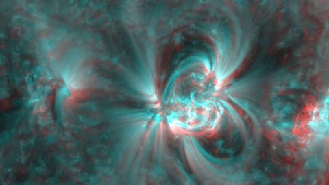 Red and blue-colored lines forming swirling shapes of magnetic fields