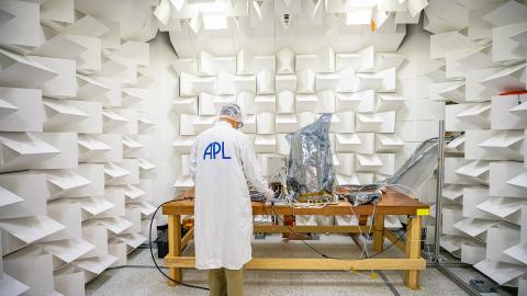 Scientist running electromagnetic tests on Lucy LORRI in APL's anechoic chamber 