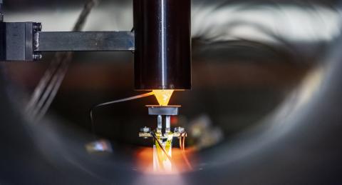 A glowing cone heats a small disc of silicon-germanium