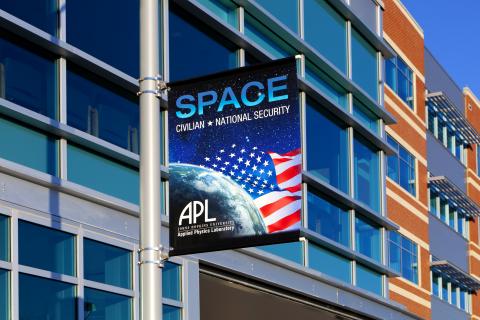 Image of space poster outside APL's Space Exploration Sector