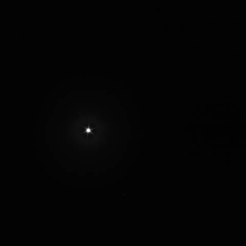 Image of the bright star Vega with six spike-like points surrounding its edge