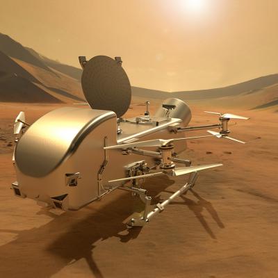 An illustration of the Dragonfly rotorcraft on the dusty surface of Titan, with dark mountains, a hazy atmosphere and the Sun in the background