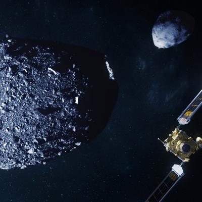A spacecraft covered in gold foil and a tiny box-like companion satellite are in a space scene, with two asteroids: one gray, ellipsoidal and covered in the rocks, the other more pyramid-like; both are gray 